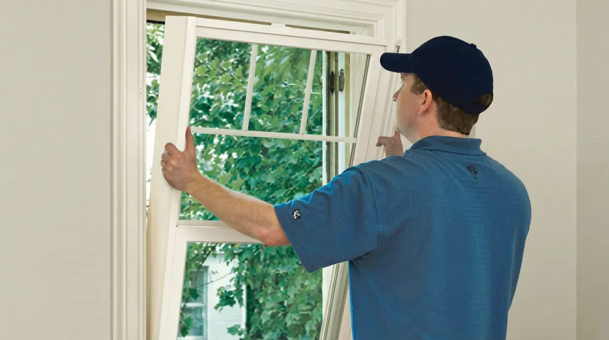 Professional contractors performing a residential window insulation and replacement service in Indianapolis, IN